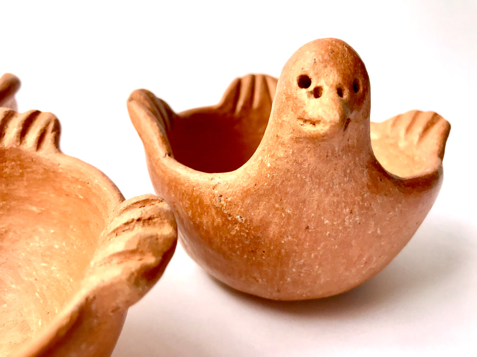 Mexico 1492: Graceful salsa bowl shaped as a bird with wings, made from red clay with a yellowish tone and marked with random flame spots, adding character. Best for serving salsa, appetizers, or salt and spices. Lead free, unglazed. Thanks to the artisanal nature of this handmade product, no two pieces are the same. 