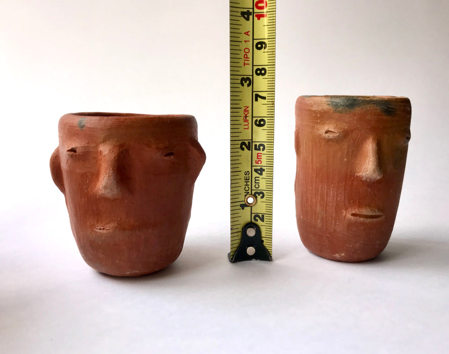 Mexico 1492: Stunning shot glasses with Zapotec profile-shaped ornaments, made from red clay and marked with random flame spots, adding character. Excellent for serving tequila or mezcal. Lead free, unglazed. Thanks to the handmade nature and the flame marks, no two pieces are the same, or even of the same height, which adds a lot of charm and informality. 