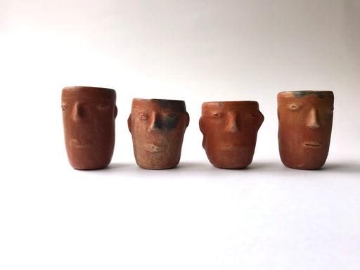 Mexico 1492: Stunning shot glasses with Zapotec profile-shaped ornaments, made from red clay and marked with random flame spots, adding character. Excellent for serving tequila or mezcal. Lead free, unglazed. Thanks to the handmade nature and the flame marks, no two pieces are the same, or even of the same height, which adds a lot of charm and informality. 