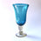 Mexico 1492: Shaped like a colored bell, with a transparent stem and foot, and hundreds of air bubbles reflecting the light, these classic wine glasses are a centerpiece and a conversation starter. Hand made with care, reflecting decades of traditional Mexican glass factories.  Available in Amethyst Purple, Turquoise, Fire Red, Cobalt Blue, Emerald Green, Lime Green and Smoke. 
