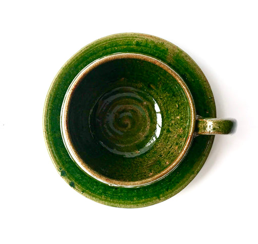 Mexico 1492: A wide, green glazed clay cup, with beautiful texture on the outside, and a symbolic swirl on the inside. Ideal for the morning cup of rich, foamy Oaxacan coffee, and a piece of sweet bread served with it.   Lead-free, handmade and glazed by the amazing artisans in Oaxaca, Mexico. 