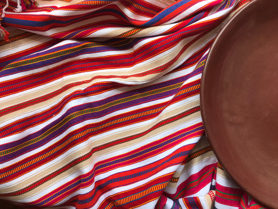 Mexico 1492: Astonishing color combinations and unrepeatable patterns come out of the imagination and skillful hands of the Chiapas artisans. The centuries old traditions of weaving using the back-strap looms is still cherished and passed on, from mothers to daughters.  Unique piece - red, purple and beige stripes on white background. L 210cm (82.7"), W 96cm (37.8")