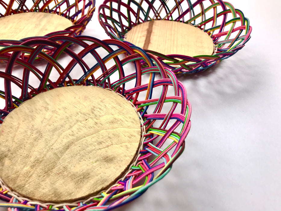 Mexico 1492: Thin wicker strings in many colors flow together and create this cheerful bread basket with a wooden base. Hand made by artisans from Estado de Mexico. 