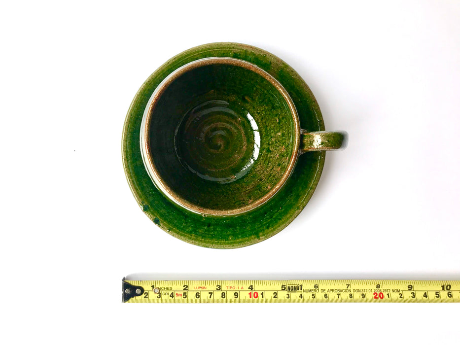 Mexico 1492: A wide, green glazed clay cup, with beautiful texture on the outside, and a symbolic swirl on the inside. Ideal for the morning cup of rich, foamy Oaxacan coffee, and a piece of sweet bread served with it.   Lead-free, handmade and glazed by the amazing artisans in Oaxaca, Mexico. 