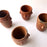 Mexico 1492: Stunning shot glasses with Zapotec profile-shaped ornaments, made from red clay and marked with random flame spots, adding character. Excellent for serving tequila or mezcal. Lead free, unglazed. Thanks to the handmade nature and the flame marks, no two pieces are the same, or even of the same height, which adds a lot of charm and informality. 