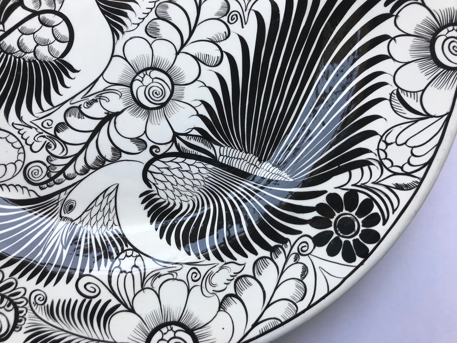 Mexico 1492: The talented young artisan Isabel from Guerrero created this amazing, large, black and white serving plate, hand painted with motifs of birds and greenery, and glazed. An eye-catcher, and a piece that beings the traditional folk art to the modern era in a seamless way.