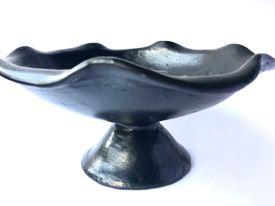 Handmade pedestal fruit bowl, with a curvaceous edge, carved my the skillful Oaxacan artisans out of the famous black clay. 