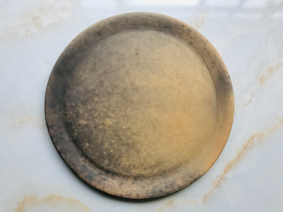Mexico 1492 - Thick brown clay plates, with uneven, unpredictable patterns of smoke stains, that can just leave a light shade or cover the plate completely.