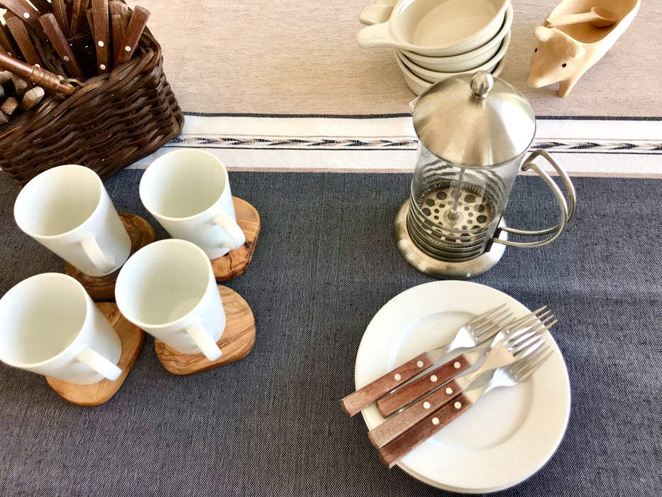 Mexico 1492: Pure cotton tablecloths with 4 stripes and braids, handmade on a pedal loom, by tenured, skillful artisans in one of the oldest, family-owned weaving workshops in Patzcuaro, Michoacan.   Available in 4 color combinations: Charcoal, Charcoal & Pebble, Pitaya & Grape and Oaxaca Sand. Each comes with 8 matching napkins.  L 2m (78.7") x W 2m (78.7")