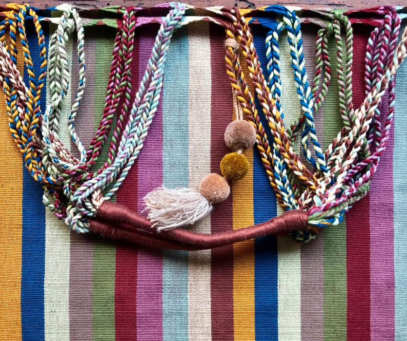 Mexico 1492 - Good for any market shopping, plus environmentally friendly.   Hand-woven on a back-strap loom by the imaginative artisans in Chiapas, Mexico, from hand-dyed cotton. Suave, more neutral colors have been put together masterfully, and adorned with a tassel of similar colors.