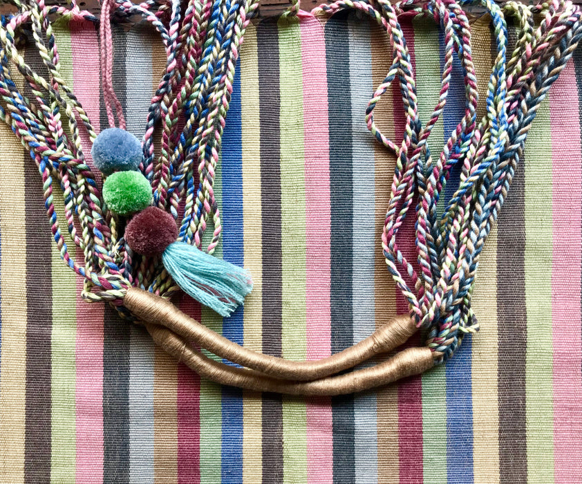 Mexico 1492 - Good for any market shopping, plus environmentally friendly.   Hand-woven on a back-strap loom by the imaginative artisans in Chiapas, Mexico, from hand-dyed cotton. Suave, more neutral colors have been put together masterfully, and adorned with a tassel of similar colors.