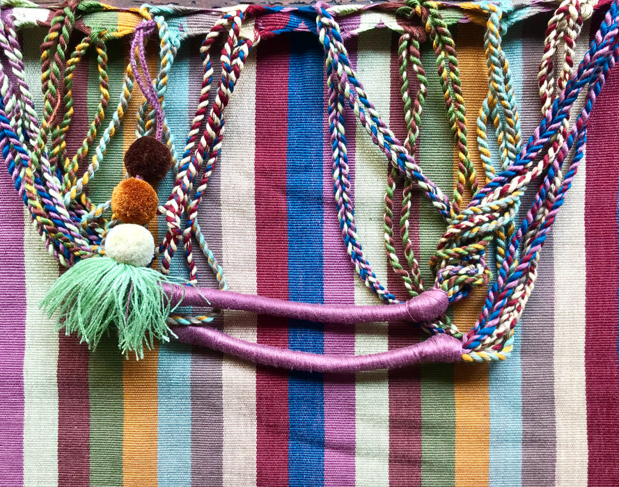 Mexico 1492 - Good for any market shopping, plus environmentally friendly.   Hand-woven on a back-strap loom by the imaginative artisans in Chiapas, Mexico, from hand-dyed cotton. Suave, more neutral colors have been put together masterfully, and adorned with a tassel of similar colors.