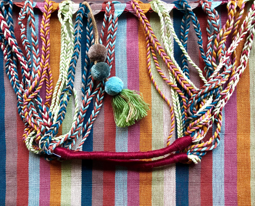 Mexico 1492 - Good for any market shopping, plus environmentally friendly.   Hand-woven on a back-strap loom by the imaginative artisans in Chiapas, Mexico, from hand-dyed cotton. Suave, more neutral colors have been put together masterfully, and adorned with a tassel of similar colors.