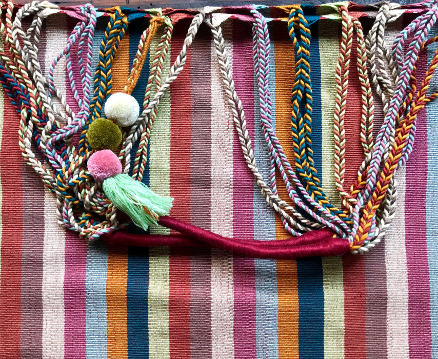 Mexico 1492 - Good for any market shopping, plus environmentally friendly.   Hand-woven on a back-strap loom by the imaginative artisans in Chiapas, Mexico, from hand-dyed cotton. Suave, more neutral colors have been put together masterfully, and adorned with a tassel of similar colors.