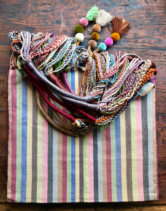Mexico 1492 - Good for any market shopping, plus environmentally friendly.   Hand-woven on a back-strap loom by the imaginative artisans in Chiapas, Mexico, from hand-dyed cotton. Suave, more neutral colors have been put together masterfully, and adorned with a tassel of similar colors.